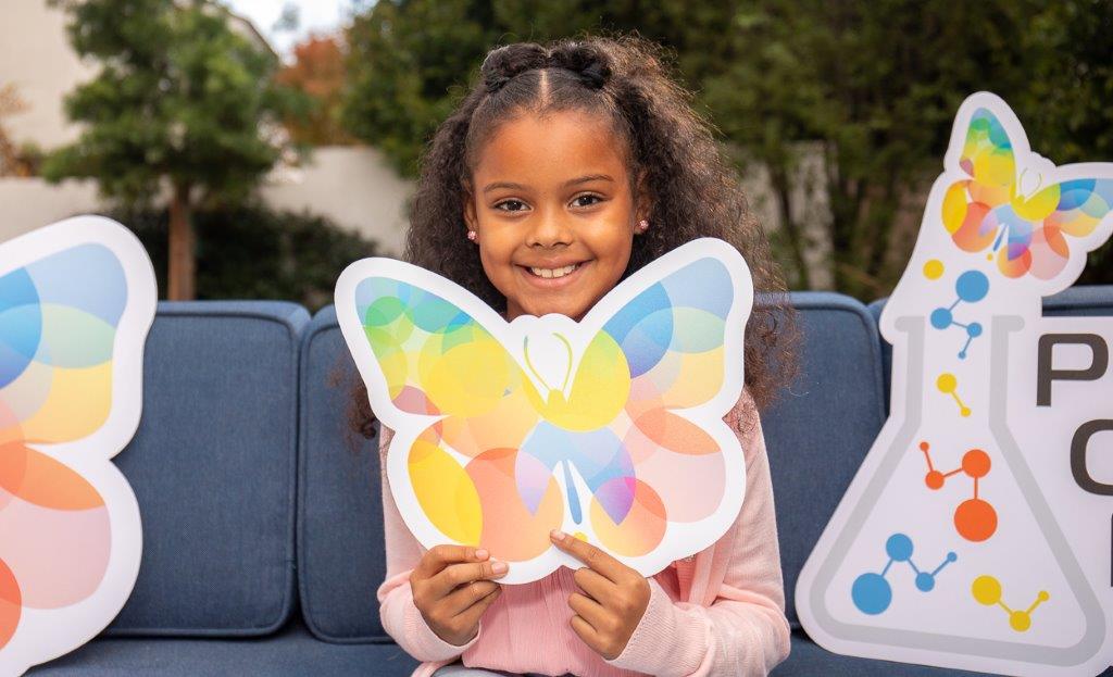 child holding butterfly board