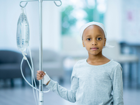 A young pediatric cancer patient hooked up to an IV