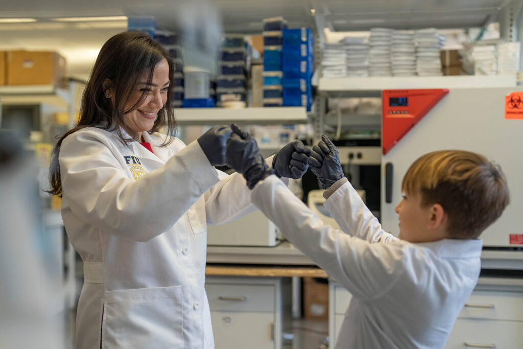 Researcher Diana Azzam and study participant Logan Jenner in the Azzam Lab at Florida International University. (Photo courtesy of FIU)